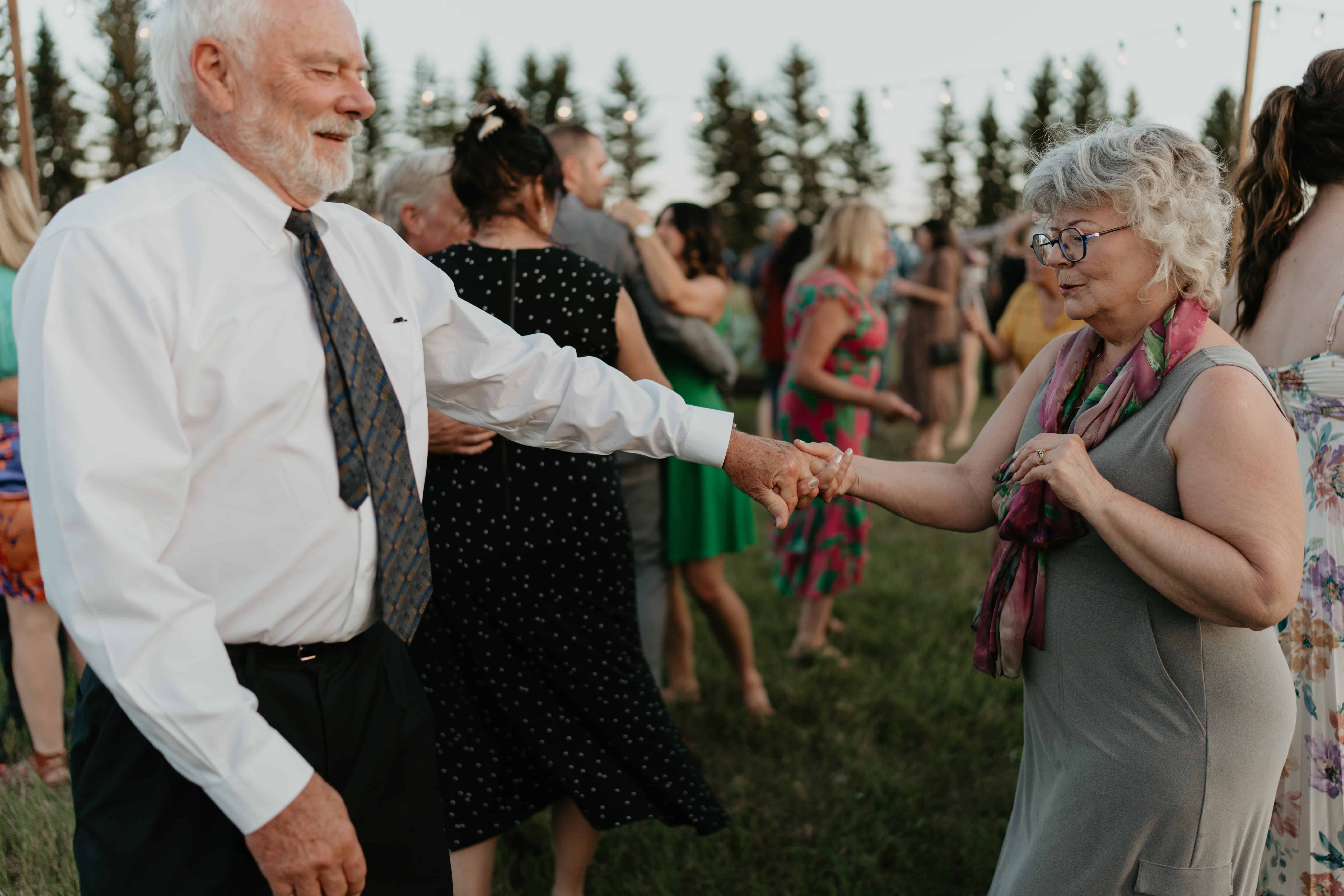 candid photo of bride's parents dancing during wedding reception. documentary wedding photographer