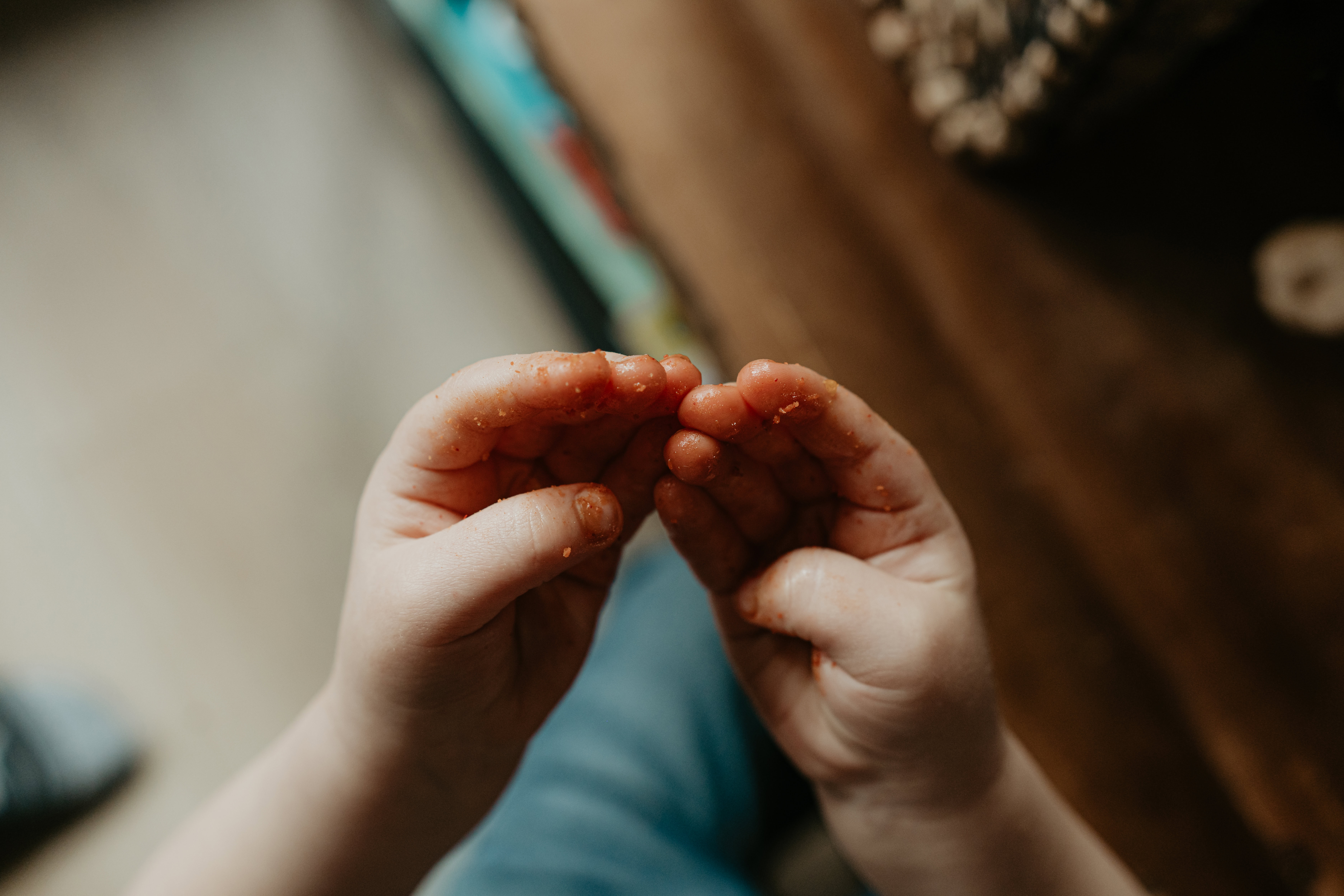 toddler with cheeto fingers