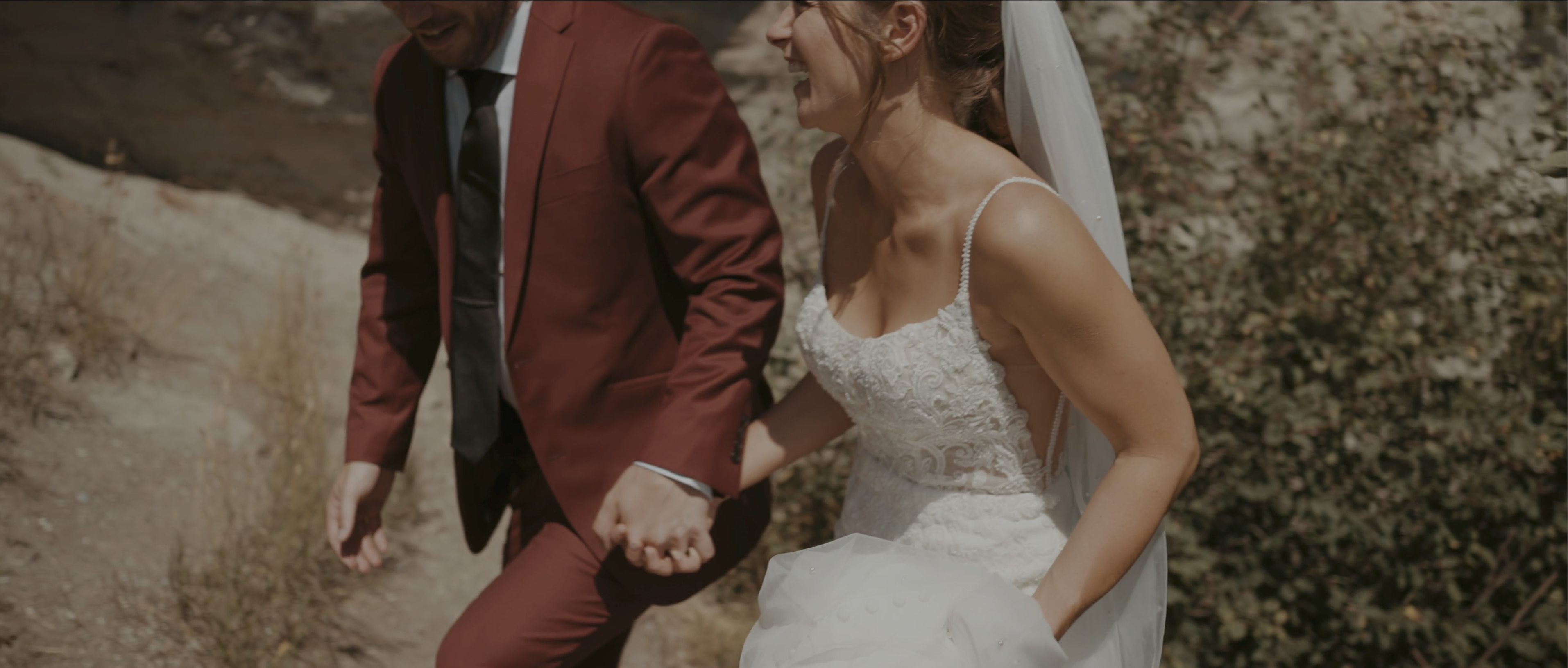 bride and groom walking up hill in crowsnest pass